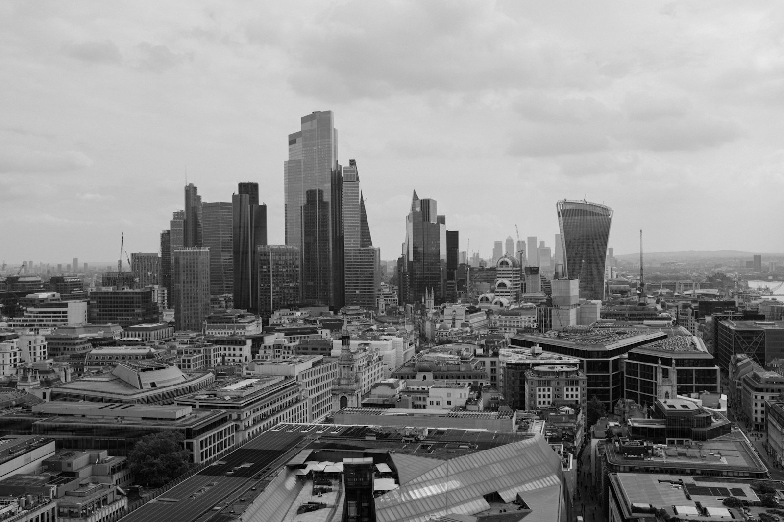 Overcast sky above a modern cityscape with numerous tall buildings